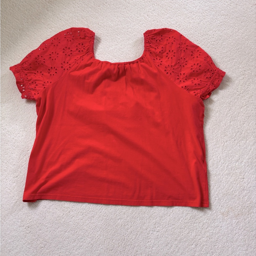 Orange jersey top with eyelet puff sleeves